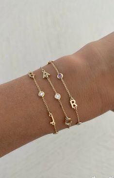 This beautiful bracelet features up to six 14K gold letters of your choice. Choose from several options for the accent stones! EXAMPLE SHOWN: Letter #1: R Stone #1: diamond Letter #2: J Stone #2: diamond Letter #3: J Available in 14K Yellow Gold, 14K White Gold or 14K Rose Gold Measures 6" + 1" extender Letter measures approx. 5mm Each letters measurement will vary slightly based on the letter FINAL SALE Friendship Bracelets With Initials, Letter Bracelets Gold, J Bracelet Letter, Cheap Birthday Charm Bracelet With Letter Beads, Diamond Letter Bracelet, Anniversary Yellow Gold Name Bracelet With Diamond Accents, Elegant Diamond Bracelets With Initials, Anniversary Yellow Gold Diamond Name Bracelet, Diamond Name Bracelet For Gift, Fine Jewelry