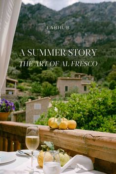 the cover of a book with an image of mountains in the background and wine glasses on a table