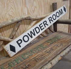 a wooden bench with a sign that says powder room on it