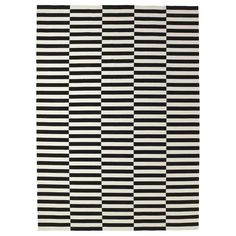 a black and white rug with vertical stripes