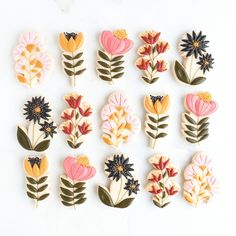 a bunch of flowers that are on some kind of brooching set up in the shape of buttons