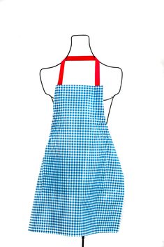 a blue and white checkered apron on a mannequin stand with red straps