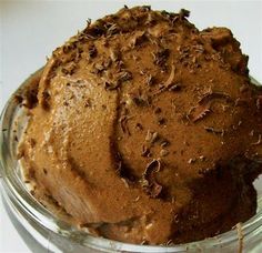 a bowl filled with chocolate ice cream on top of a table