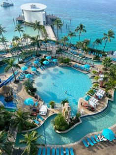 an aerial view of a resort pool and beach