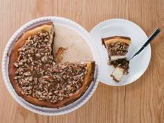 a piece of pie sitting on top of a white plate next to a slice of cake