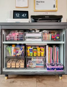 an office desk with clear storage containers on it's sides and drawers underneath the desk