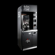 a black and silver coffee vending machine with writing on the side that says, the real smile of coffee