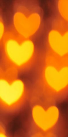 the blurry image shows many hearts in yellow and orange colors, as well as an orange background