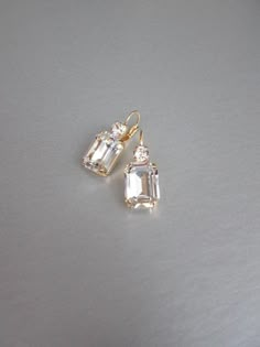 "These beautiful elegant earrings are made with fancy emerald cut and round Swarovski crystals. Available in gold, rose gold and silver finish. Matching necklaces an the bracelet are also available and they are shown in the last two photos. - 1 3/8\" long from the top of the ear wire to the bottom of the earring and 1/2\" wide - Leverback - For the matching bracelet please take a look here: https://www.etsy.com/listing/754440549/swarovski-crystal-bridal-bracelet-gold?ref=shop_home_active_19& Bridal Gold Earrings, Wedding Drop Earrings, Inexpensive Jewelry, Earrings Emerald, Gold Bridal Earrings, Wedding Earrings Drop, Matching Jewelry, Jewelry Lookbook, Earrings In Gold