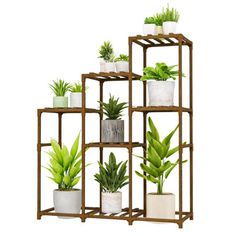 a set of four shelves with plants in them