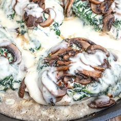 a pizza with mushrooms, spinach and cheese on it