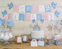 a table with cake, cupcakes and decorations on it