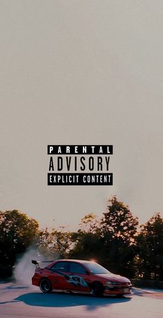 a red car driving down a road with the words parental advisory explicit content above it