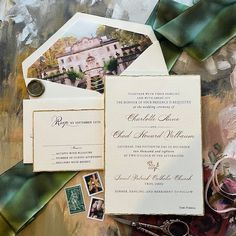 wedding stationery with photos and ribbons on top of the paper, surrounded by other items