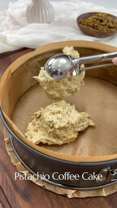 a person scooping something out of a pan with a ladle on top of it