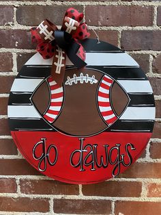 a painted football sign on a brick wall