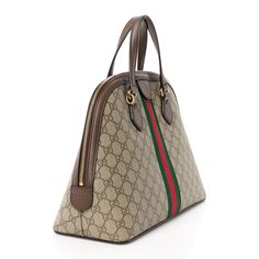 This is an authentic GUCCI GG Supreme Monogram Web Medium Ophidia Top Handle Dome Bag in Brown. This chic handbag is crafted of brown on beige Gucci GG monogram coated canvas with a red and green canvas web stripe down the center. The bag features brown leather top handles, trim with polished gold hardware. The top zipper opens to a beige microfiber interior with zipper and patch pockets. Gucci Ophidia Bag, Dome Bag, Brown Leather Top, Small Messenger Bag, Gg Monogram, Vintage Monogram, Gucci Shoulder Bag, Monogram Bag, Chic Handbags