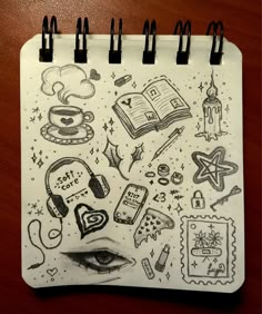 a spiral notebook with drawings on it