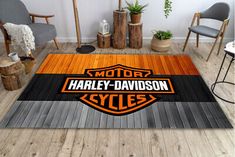 the harley davidson logo is on an area rug in a room with chairs and potted plants