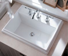 a white sink sitting on top of a bathroom counter