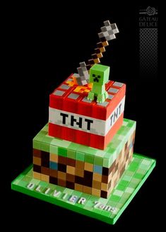 a cake made to look like a minecraft creeper with the word tht on it