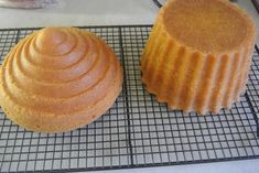 two cakes sitting on top of a cooling rack next to each other in front of a cupcake tin