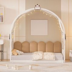 a white day bed sitting in a living room next to a wall with lights on it