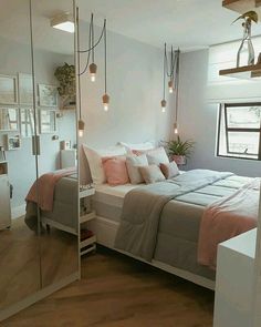 a bed sitting in a bedroom next to a window with lots of light on it