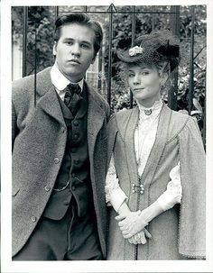 an old black and white photo of a man and woman standing next to each other