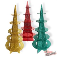 three different colored plastic christmas trees with glitter on the top and bottom one is red, one is green