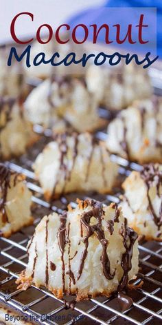 coconut macaroons on a cooling rack with chocolate drizzled over them