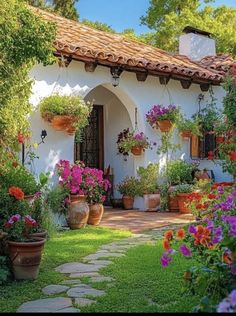 a house with potted plants and flowers in the front yard