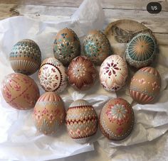 an assortment of painted eggs on wax paper