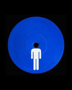 a blue disk with a white man on it in the center and an oval hole at the bottom