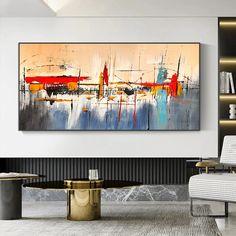 an abstract painting hangs on the wall in a modern living room