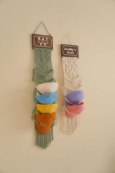 two wall hangings made out of macrammeal and other items on the wall