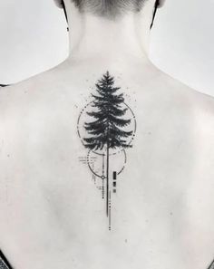 a man's back with a tree tattoo on it