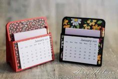 two small desk calendars sitting next to each other on top of a wooden table