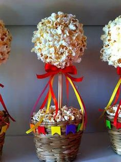 three small baskets filled with popcorn and candy