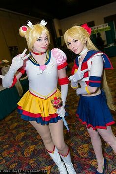 two women dressed in costumes posing for the camera