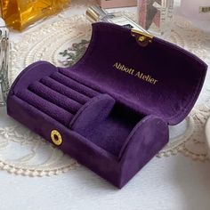 a purple velvet jewelry case sitting on top of a table