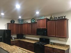 a kitchen with brown cabinets and black appliances