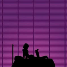 a woman sitting on top of a bed in front of a purple wall with vertical blinds