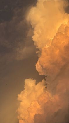 an airplane is flying in the sky with clouds