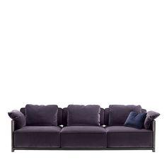 a purple couch with pillows on it against a white background