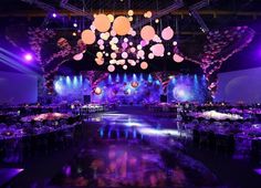 an image of a party setting with purple lighting and balloons hanging from the ceiling at night