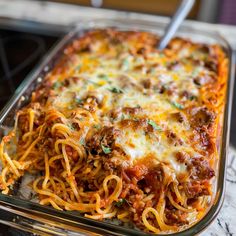 a casserole dish with spaghetti and meat in it