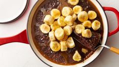 a pan filled with brownie and bananas on top of a table