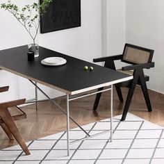 a table with two chairs and a plate on it in the middle of a room