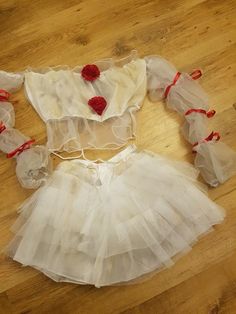 two pieces of white tulle skirt with red flowers on the top, and one piece is